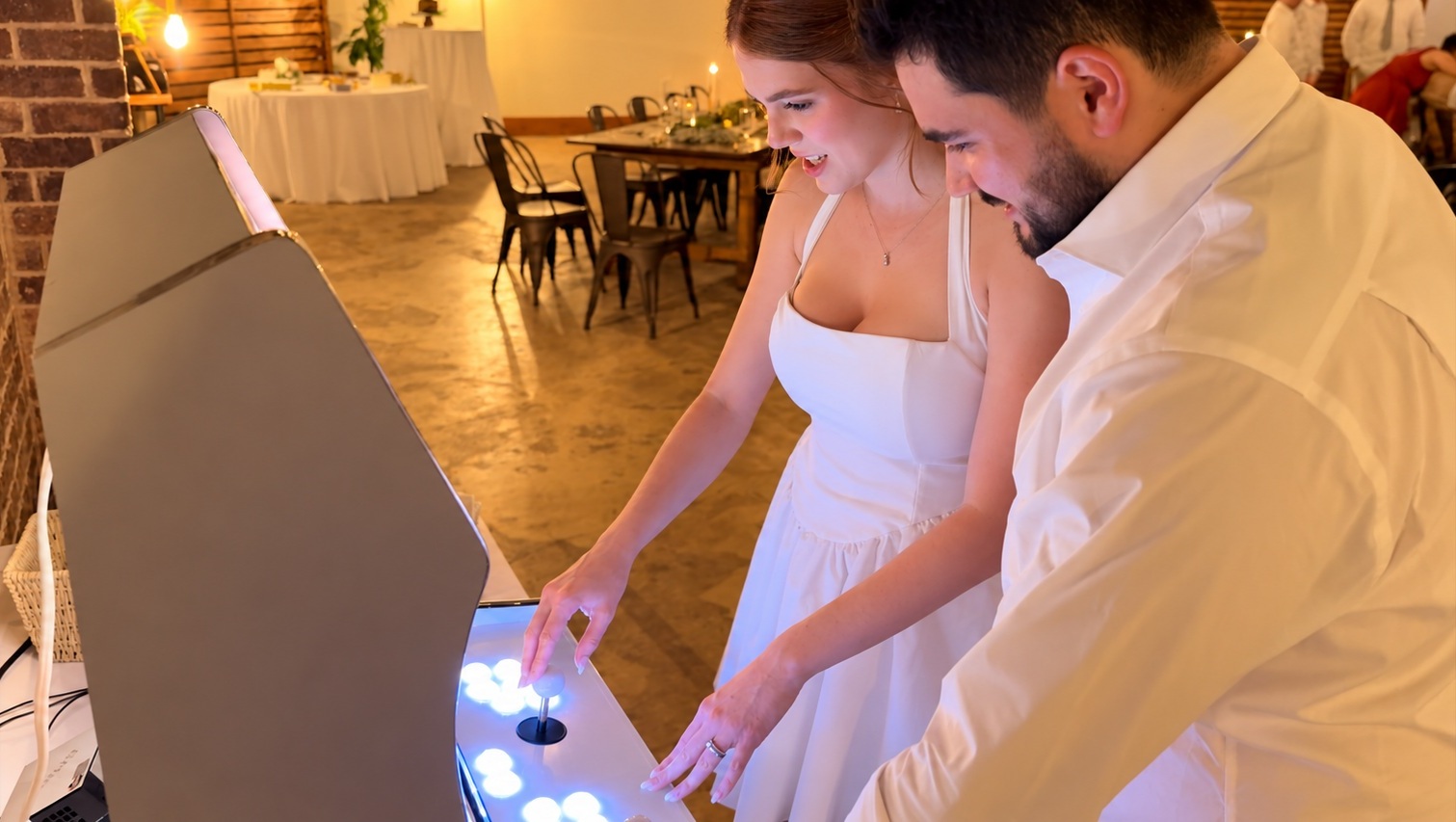 Laura and Nathan playing their wedding arcade game together